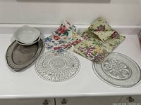Entire lot showing bowls, metal tray, placemats, runner, two glass plates