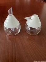 Pair of glass dispensers with lids and spouts