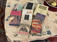 All eight books laid out showing titles and formats