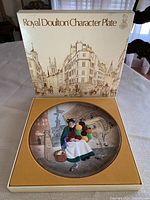 Plate inside original presentation box, box lid visible