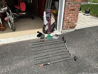 All clubs, bag and accessories laid out on driveway