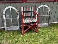 Two arched window frames and director's chair front view outdoors