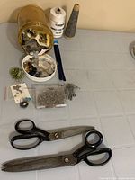 Full lot overview showing shears, buttons jar, pins, safety pins, zippers, thread cones