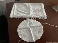 Tablecloth folded and round liner displayed