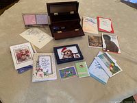 All items laid out: open desk organizer, greeting cards, sticky pads, dog frame
