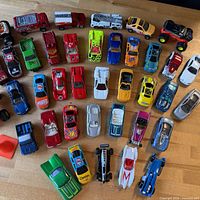 Overview of entire lot showing 39 die-cast vehicles in varied colors and styles
