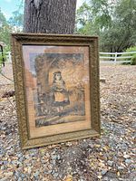 Front view of framed print leaning against tree