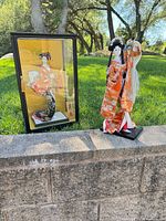 Both Geisha dolls side by side, one inside glass case, one on open base