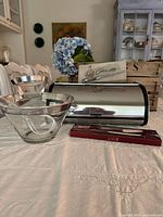 Bread box, two clear glass bowls, Carve-ette box, Museum Re-Creations box visible