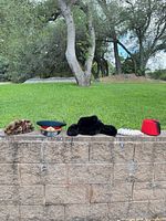 Five hats lined on wall outdoors