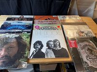 Group shot of all 16 albums spread on table