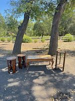 Overview of four brown distressed wood tables set outdoors