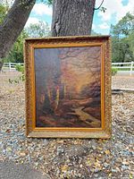 Front view of framed oil landscape painting
