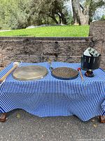 Overall lot showing both gongs, mallets, zoetrope on blue check cloth