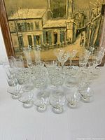 Group shot showing all 24 pieces: tumblers, flutes, assorted coupes