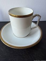 Cup seated on saucer showing shape and rim trim