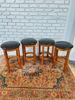 Full view of all four barstools on rug