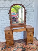 Front view of solid wood vanity with attached arched mirror