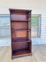 Front view of shelf showing four tiers and overall condition