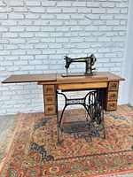 Full view of Singer treadle sewing machine with cabinet and base