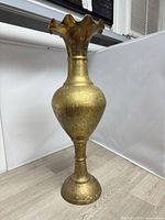 Full view of tall etched brass vase