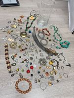 Full lot spread showing all jewelry pieces and glass vase
