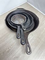all four skillets nested together top view