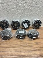 Seven sealed octagonal pill organizers grouped together