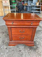 front view showing pull-out tray and two drawers