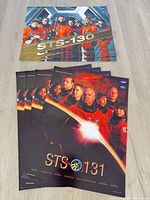 Stacks of STS-130 and STS-131 posters grouped