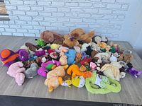 Pile view showing full assortment of stuffed animals on tabletop