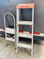 Two ladders standing side by side