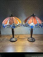 Front view of both Tiffany style lamps illuminated
