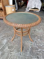 Full view of round wicker glass-top table