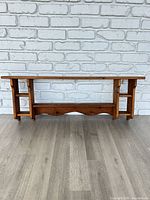 Front view of entire wooden wall shelf