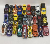 All 27 Hot Wheels cars laid out in rows