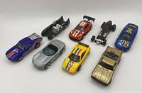 All eight Hot Wheels cars aligned side by side