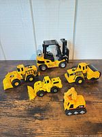 Group shot of all five yellow and black die-cast construction vehicles