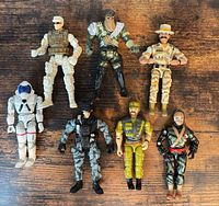 Group shot of all seven 3.75 in action figures laid out on table