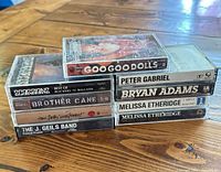 Stack of cassette spines showing artist names and case condition