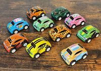 All 10 multicolor pull-back toy cars on wooden surface