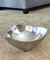 Top view of polished Nambe bowl showing wavy rim