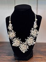 Front view of entire necklace on display bust