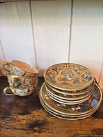 Overall lot showing stacked saucers and teacups