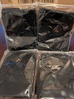 Four individually packaged black mesh sunshades in clear bags