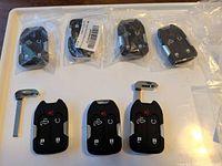 Seven key fobs; four bagged, three unbagged with blades