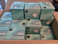 Open carton showing multiple sealed JFQ KN95 mask boxes