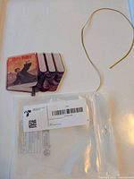 Ornament, gold string, empty plastic bag