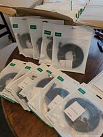 Multiple sealed UGREEN Cat 8 cable pouches displayed on table