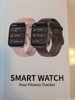 Retail box front showing pink and black versions, product name Smart Watch Your Fitness Tracker